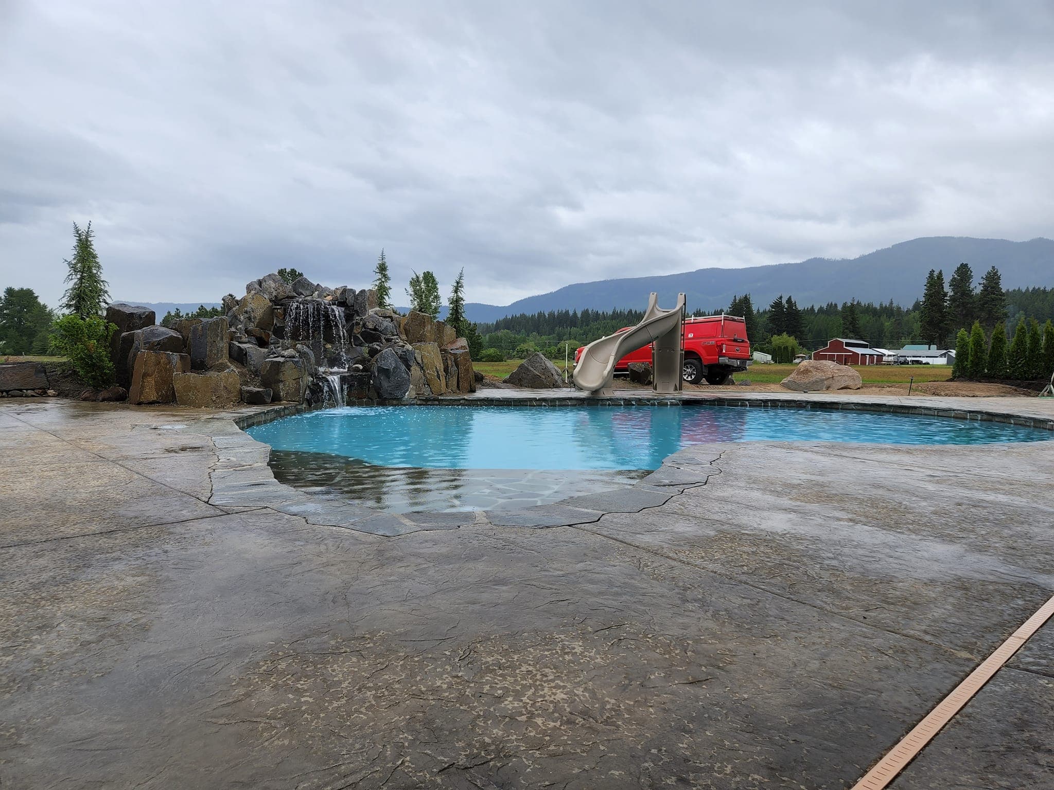 Custom pool waterfall with slide and rocks Wenatchee